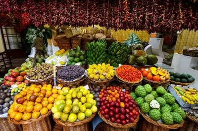 a display of fruits and vegetables in baskets at a market at Guest house Santa Maria in Funchal