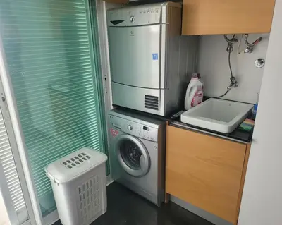 a small kitchen with a washing machine and a washer at Nova Madeira Apartment Machico in Machico