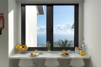a window with a table with fruit on it at OurMadeira - Monte White House in Funchal
