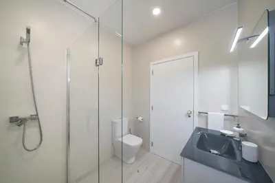 a bathroom with a shower and a toilet and a sink at OurMadeira - Monte White House in Funchal