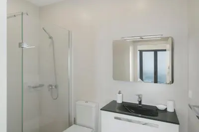 a bathroom with a toilet and a sink and a shower at OurMadeira - Monte White House in Funchal