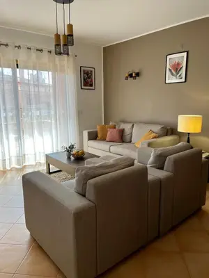 a living room with two couches and a table at Margarida Apartment in Luz