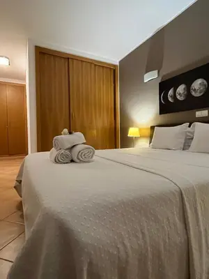 a hotel room with a bed with towels on it at Margarida Apartment in Luz