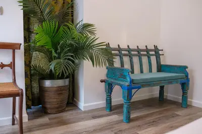 a blue chair sitting next to a potted plant at GuestReady - A marvellous stay in Calheta in Calheta