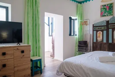 a bedroom with a bed and a television on a dresser at GuestReady - A marvellous stay in Calheta in Calheta