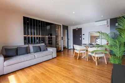 a living room with a couch and a table at Madeira Four Seasons in Funchal