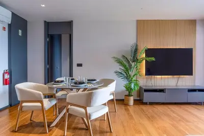 a dining room with a table and chairs and a tv at Madeira Four Seasons in Funchal