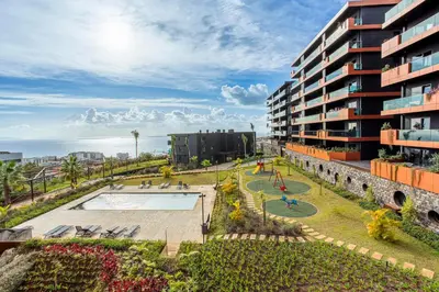 an apartment building with a pool and a playground at Madeira Four Seasons in Funchal