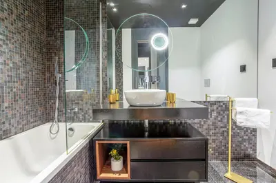a bathroom with a sink and a tub and a mirror at Madeira Four Seasons in Funchal