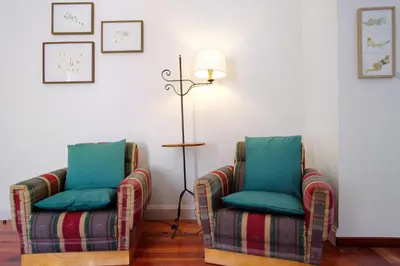 two chairs and a lamp in a room at Mother's House in Calheta
