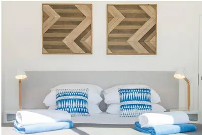 two blue and white pillows sitting on a bed at Casa Vista da Praia in Luz