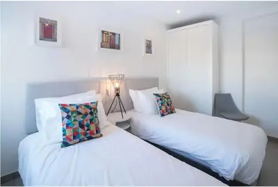 two beds sitting next to each other in a bedroom at Casa Vista da Praia in Luz
