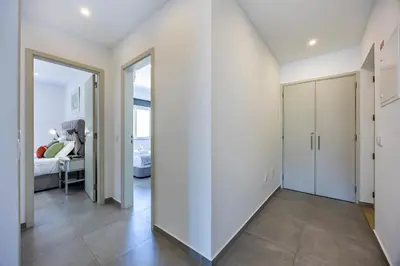 a room with a white wall and a bedroom at Casa de Férias, Luz in Luz