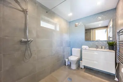 a bathroom with a shower and a toilet and a sink at Casa de Férias, Luz in Luz