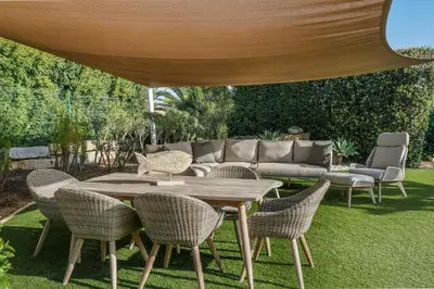 a patio with a table and chairs and a couch at Vivenda Kristina in Luz