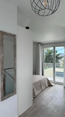 a bedroom with a mirror and a bed and a window at VCS House by Madeira Holiday in Funchal
