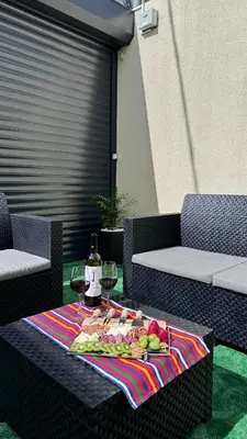 a table with a plate of fruit and wine glasses at VCS House by Madeira Holiday in Funchal