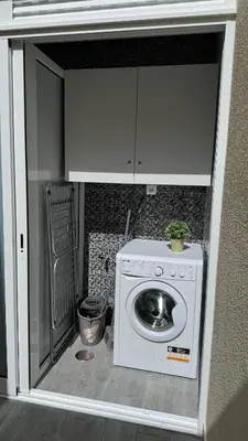 a kitchen with a washing machine in a room at VCS House by Madeira Holiday in Funchal
