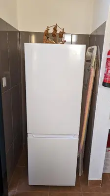 a white refrigerator freezer sitting in a kitchen at Banana Tree House in Ponta do Sol