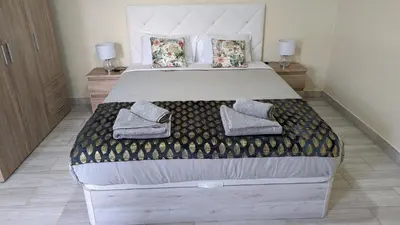 a bedroom with a bed with two slippers on it at Banana Tree House in Ponta do Sol