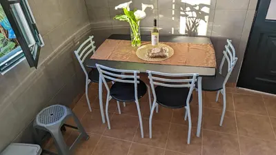 a small table and chairs in a small kitchen at Banana Tree House in Ponta do Sol