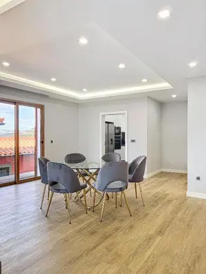 a dining room with chairs and a glass table at Villa Faísca in São Roque do Faial