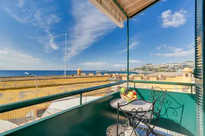 a balcony with a table and chairs and the ocean at Marias Place by Atlantic Holiday in Funchal