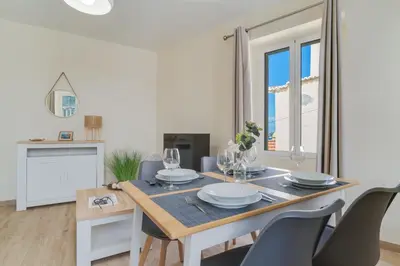 a white dining room with a table and chairs at Marias Place by Atlantic Holiday in Funchal