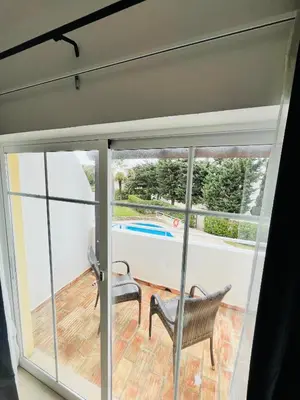 a sliding glass door with a view of a pool at Casa Da Praia in Luz