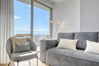 a living room with a couch and a chair at The Place by Nicolene, a Home in Madeira in Funchal