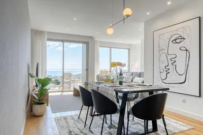 a dining room with a black table and chairs at The Place by Nicolene, a Home in Madeira in Funchal