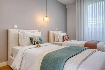 a bedroom with two beds with stuffed animals on them at The Place by Nicolene, a Home in Madeira in Funchal