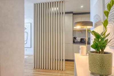 a living room with a plant in a vase at The Place by Nicolene, a Home in Madeira in Funchal