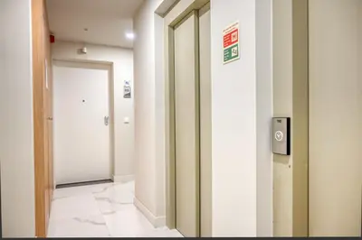 a hallway with a mirror and a door at The Place by Nicolene, a Home in Madeira in Funchal