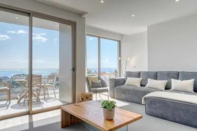 a living room with a couch and a table at The Place by Nicolene, a Home in Madeira in Funchal