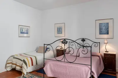 a bedroom with two beds and two night stands at Casa do Terreiro by An Island Apart in São Vicente