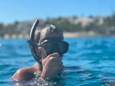 a person in the water with a diving mask at Profetas GuestHouse in Porto Santo