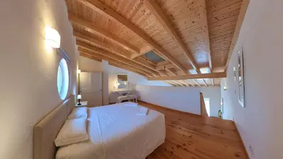 a bedroom with a white bed and a wooden ceiling at Carrapateira Retreat in Carrapateira
