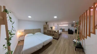 a bedroom with two beds and a desk in it at Carrapateira Retreat in Carrapateira