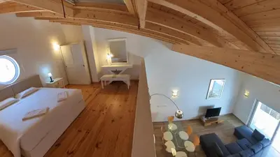 an overhead view of a bedroom with a bed and a couch at Carrapateira Retreat in Carrapateira