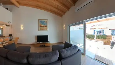 a living room with a couch and a tv at Carrapateira Retreat in Carrapateira