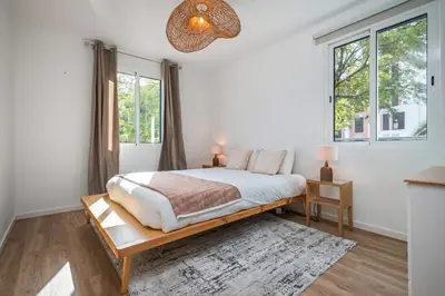 a white bedroom with a bed and two windows at Cozy Retreat - By WeHost in Funchal