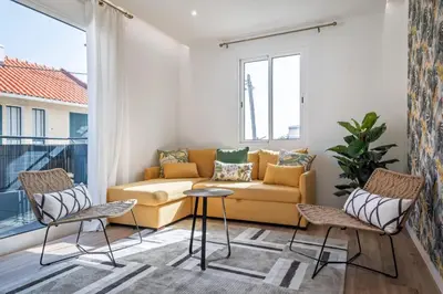 a living room with a couch and two chairs at Cozy Retreat - By WeHost in Funchal