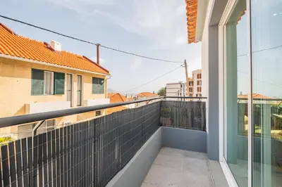 a balcony with a view of a building at Cozy Retreat - By WeHost in Funchal