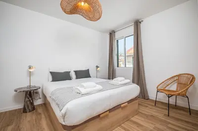 a bedroom with a large bed and a window at Cozy Retreat - By WeHost in Funchal