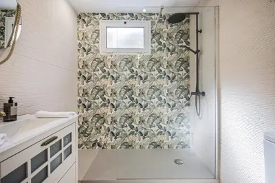 a bathroom with a shower with a mosaic wall at Cozy Retreat - By WeHost in Funchal