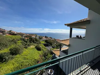 a view of the ocean from the balcony of a house at NICE and MODERN FLAT NEAR AIRPORT in Santa Cruz