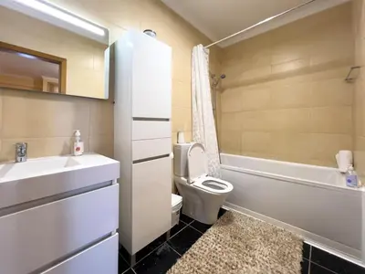 a bathroom with a sink and a toilet and a bath tub at GuestReady - One happy stay in Machico in Santa Cruz