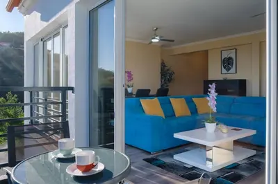 a living room with a blue couch and a table at GuestReady - One happy stay in Machico in Santa Cruz