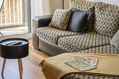 a living room with a couch and a chair at Canico City Center by Zest and Guest in Santa Cruz